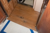 BB45 teak decking entrance to CO's Stateroom. Circles are patched bullet holes from Japanese fighters.g