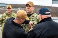 Pinning a "Pass Down the Line" Command Master Chief pin on COB Alger